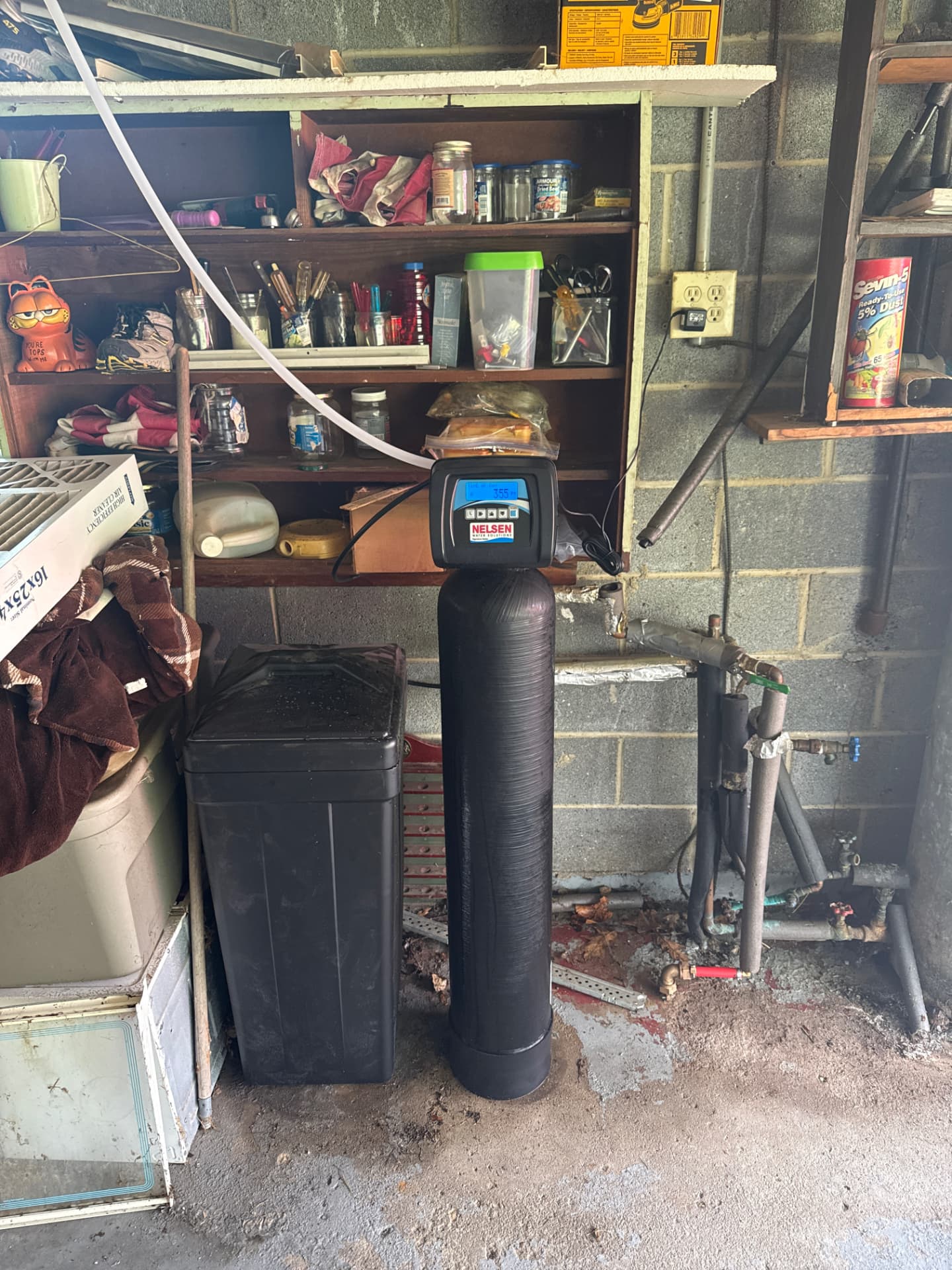 Nelsen water softener tank and brine tank installed in a residential garage