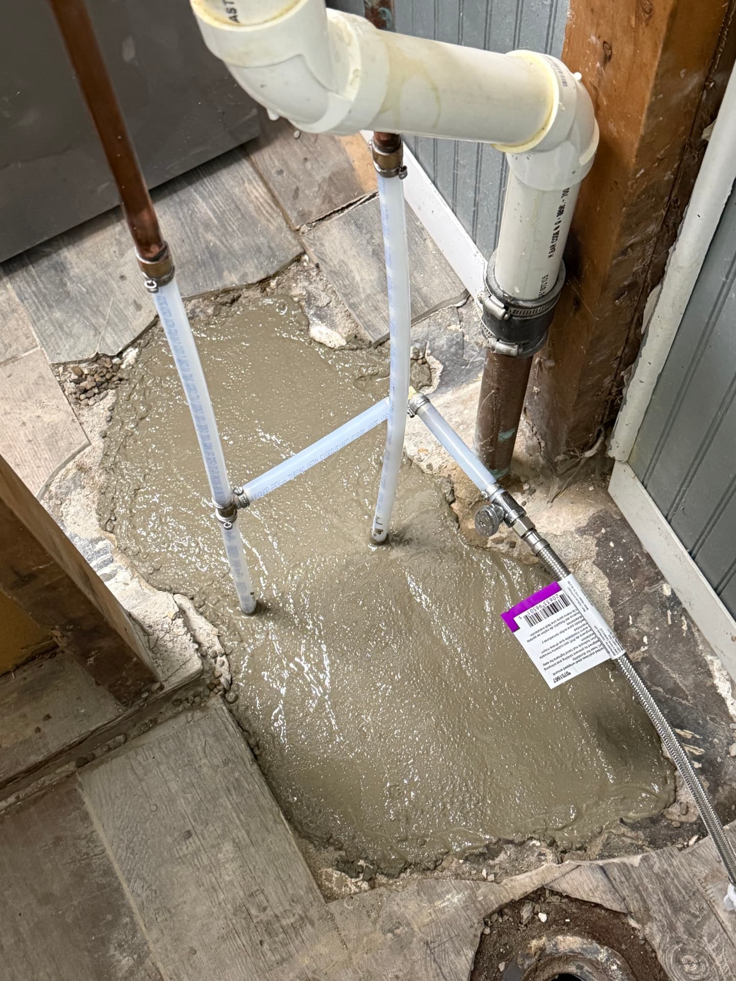 Slab leak repair completed with new PEX lines and fresh concrete poured over the access opening