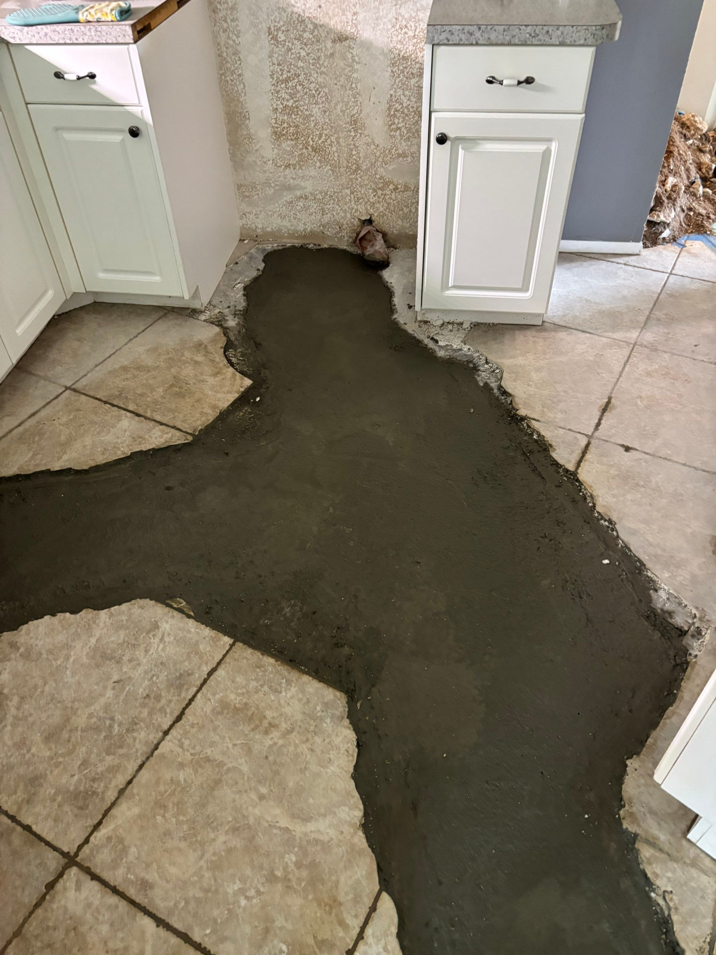 Kitchen floor trench backfilled with wet concrete after sewer line repair